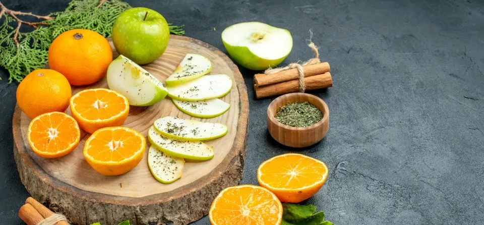 Natural Vitamin C sources like amla and orange with Ayurvedic herbs for skin brightening and rejuvenation